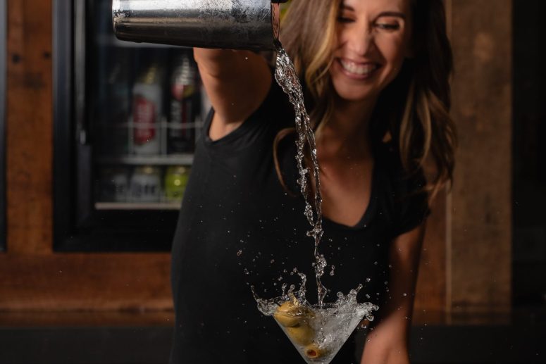 Bartender pouring drink from shaker