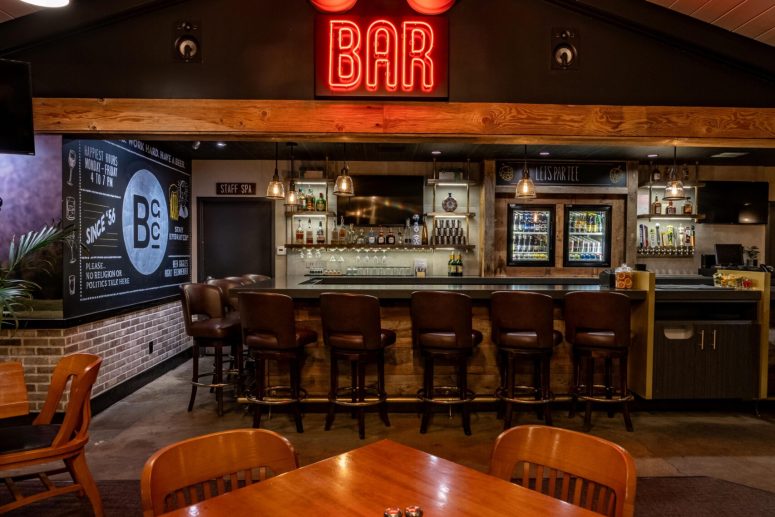 BGC Bar and Grill interior featuring a modern bar area, neon lighting, and casual dining atmosphere.